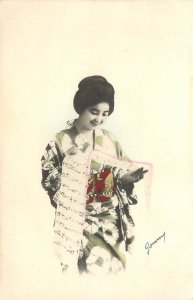 Hand Colored Postcard Smiling Japanese Woman Reading Rice Paper Scroll c1908