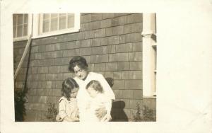 c1910 RPPC Outdoor Portrait Young Mother Comforts Unhappy Children Unknown US