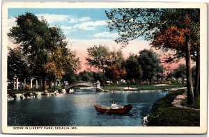 Postcard MO Sedalia Liberty Park scene woman in rowboat 1917