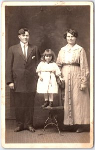 Man in Suit Thin Tie with Child,  Woman Button Dress Portrait - Vintage Postcard