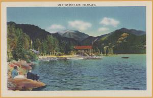 Grand Lake, Colo., People on shore, canoes & mountains -