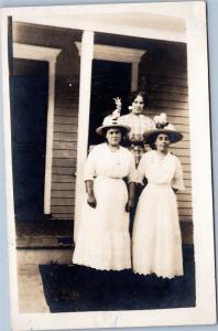 RPPC: Women's portrait: Three women in white and checkered dresses