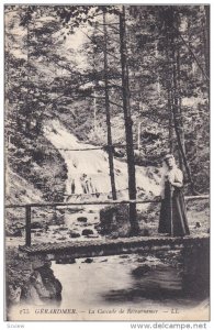 GERARDMER, Vosges, France; Woman standing on bridge over La Cascade de Retour...