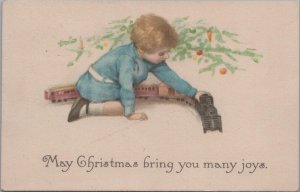 Postcard Christmas Little Boy Playing with Train 1916