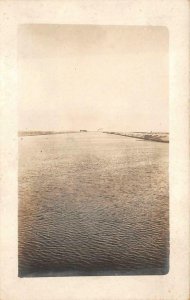 RPPC PANAMA CANAL SHIP IN DISTANCE REAL PHOTO POSTCARD (c. 1915)