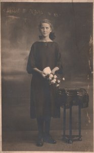 Vintage Postcard Young Woman in Black Dress Holding Flowers Portrait Real Photo