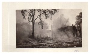Photo of a dwelling destroyed by fire still smoking in 1918 RPPC Postcard