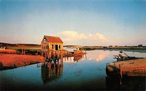 Reflections of Old Weelfleet Harbor in Wellfleet, Massachusetts on Cape Cod.