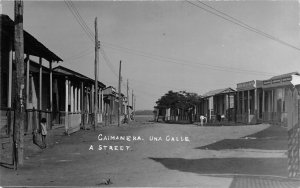 G42/ Foreign RPPC Postcard Cuba Caimanera c1920s Una Calle Street Homes Store