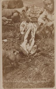 RPPC PREPARING A DOG FEAST BAGUIO PHILIPPINES REAL PHOTO POSTCARD (c. 1910)