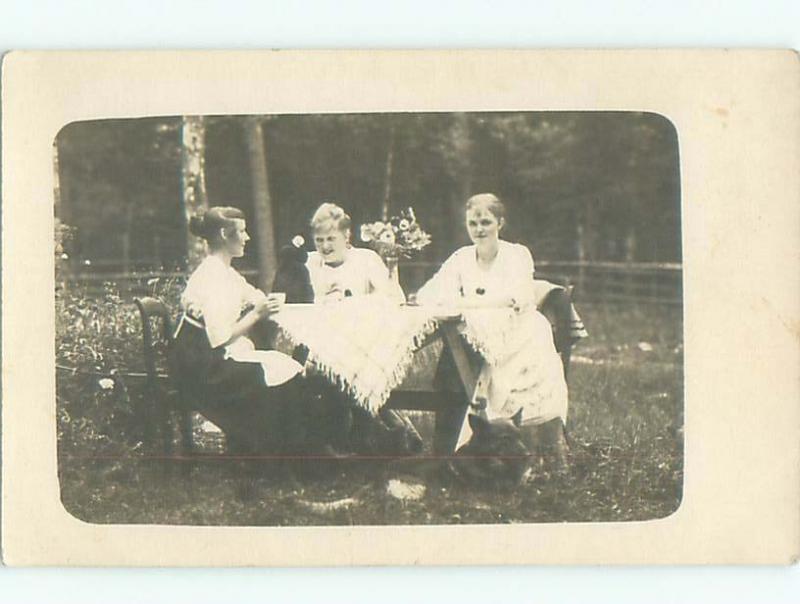 rppc c1910 WOMEN SITTING OUTDOORS AT TABLE AC8836
