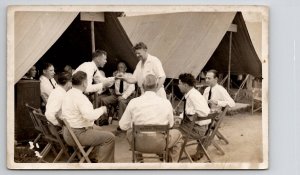 RPPC Men Sitting Around Tent Infantry Armory Chairs Real Photo Postcard J23