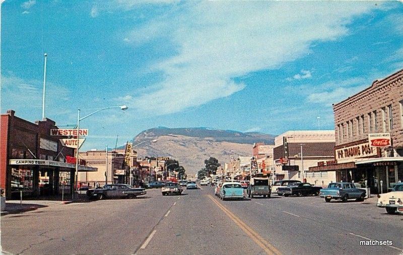 1960s City Street Scene Cody Wyoming autos Coca Cola Enterprise