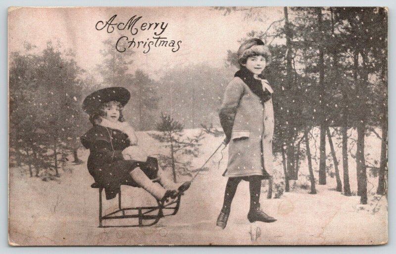 Victorian Christmas~Boy Pulls Little Sister on Sled Chair~B&W 1905 Postcard 