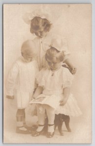 RPPC Precious Edwardian Three Children Studio Portrait with Book Postcard I23