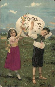 Easter Boy and Girl Giant Egg Silk Clothing c1910 Vintage Postcard