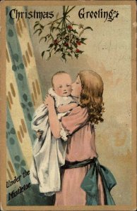 Christmas Little Girl Kisses Baby Sister Under Mistletoe c1910 Vintage Postcard