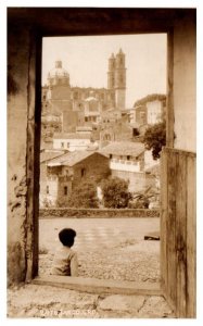 Boy in Doorway looking out towards town Taxco Mexico RPPC Postcard