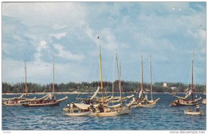 Fishing smacks in Nassau Harbor, Paradise Beach in background, Bahamas, 40-60s