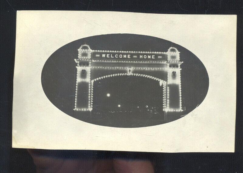 RPPC WELCOME ARCH NIGHT WWI ERA DOWNTOWN STREET SCENE REAL PHOTO POSTCARD