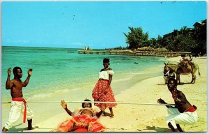 VINTAGE POSTCARD DOING THE LIMBO DANCE ON THE BEACH IN JAMAICA W.I. 1960s SCENE