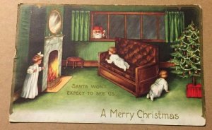 1912 USED POSTCARD EMBOSSED - SANTA LOOKING IN THE WINDOW -A MERRY CHRISTMAS