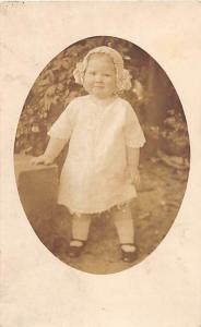 YOUNG GIRL 17 MONTHS OLD IN DRESS & HAT REAL PHOTO POSTCARD c1900s