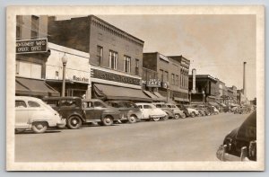 RPPC Laramie WY Business District Wards Hested Cafe Grocery Taxicab Postcard M26