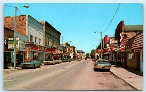 MANISTIQUE, MI Michigan ~ Street Scene BUSINESS DISTRICT c1960s Cars Postcard