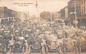 RPPC A SCENE ON BROADWAY LARNED KANSAS CARS RPO REAL PHOTO POSTCARD 1910