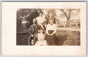 Family Posing in Yard Photo Parents & Children Portrait RPPC Vintage Postcard