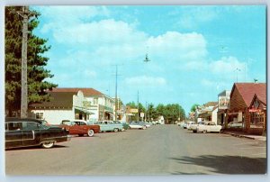 c1950's Land O' Lakes Wisconsin Main Street Classic Cars Parking Stores Postcard