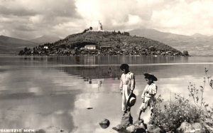 Vintage Postcard Two Boys Next to Water View of Town in Background Mexico RPPC