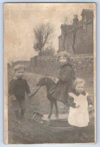 c1910's Children Ride On Rocking Horse Toy Scene Field RPPC Photo Postcard