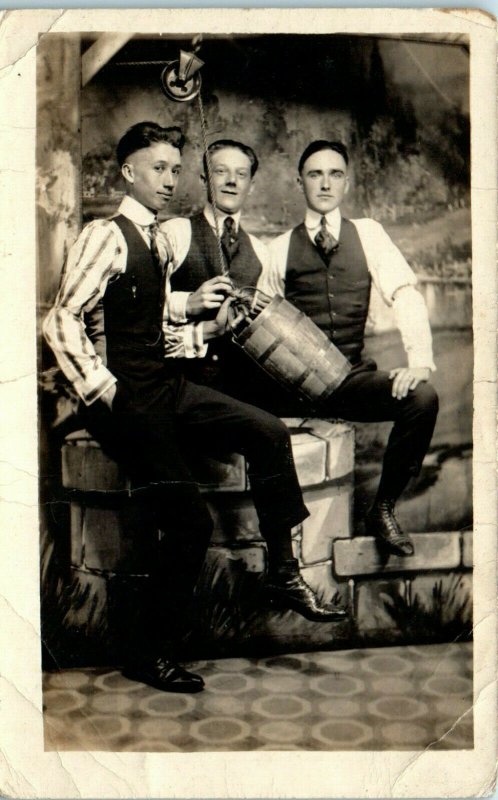 1910s Young Men Posed Wishing Well Oak Bucket Studio RPPC Real Photo Postcard