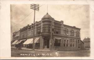 Real Photo Postcard Building on a Street Corner in Manistique, Michigan