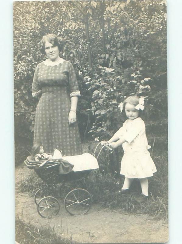 rppc 1912 GIRL PUTS HER DOLL INTO THE BABY CARRIAGE AC8183