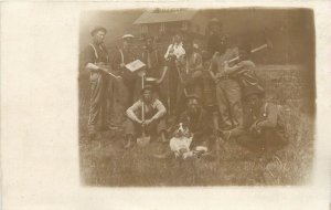 c1907 RPPC Working Men Pose for Photo w/ Border Collie Dog & Hand Tools Unposted