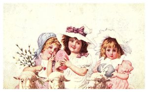 3 young girl children with sheep