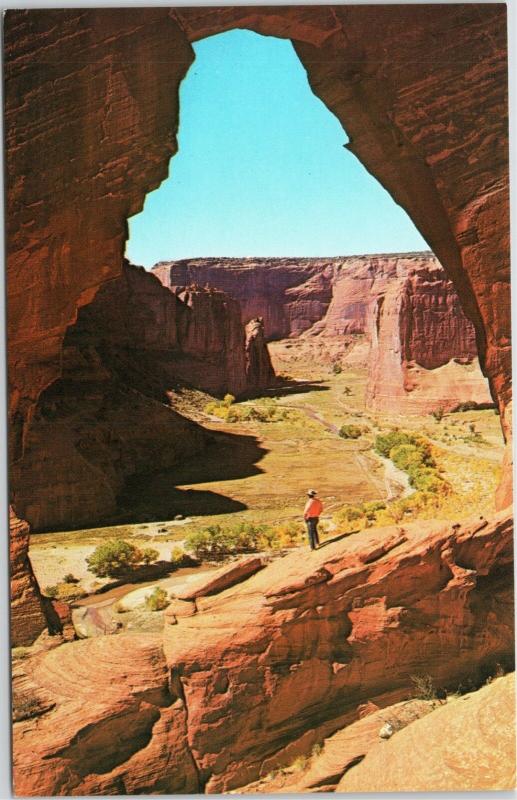postcard Canyon de Chelly - man in cowboy hat standing at The Window