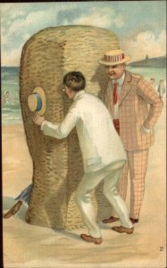 Beach Scene Men Peeking at Couple on Wicker Chair c1910 Postcard