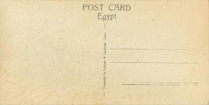 Hand-Colored 3x6 RPPC Postcard Native Quarter Cairo Egypt people & Skinny Cow