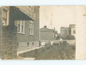 Pre-1918 rppc TWO LITTLE GIRLS WITH BROTHER AND DAD BY HOUSE o1789