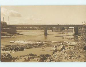 old rppc LOGS LYING IN THE RIVER SIDE BRIDGE HM0886