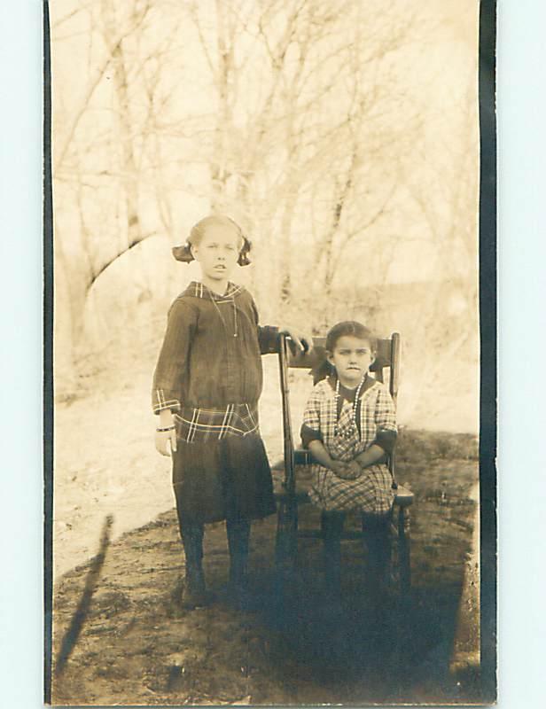 Pre-1918 rppc CUTE GIRL WITH BOW IN HAIR & SISTER ON CHAIR r5977