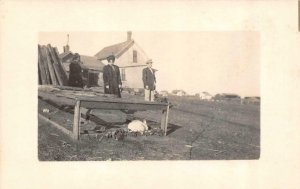 RPPC,   COUPLE On FARM Standing At RABBIT HUTCH   ca1920's Real Photo Postcard