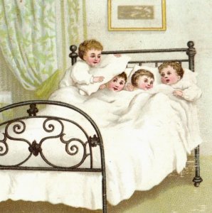 1870s-80s Victorian Christmas Card Sweet Children Playing In Bed F166