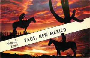 Howdy from Taos New Mexico Vintage Banner Postcard - Cowboys, Horses at Sunset