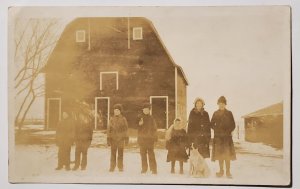 RPPC Seven Children Family Dog Winter Scene at Large Barn Photo Postcard J30