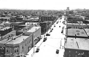 Abilene KS Aerial View Store Fronts Old Cars  Eisenhower's Home RPPC Postcard